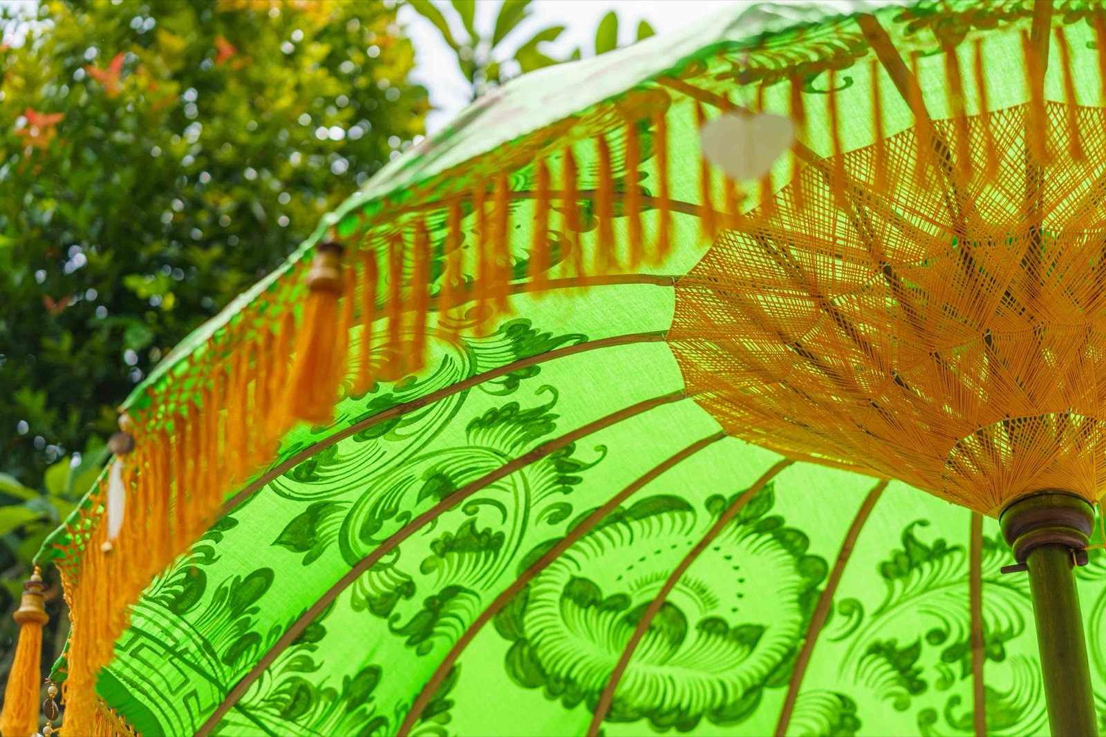 Ivory Coast Bali umbrella · Leaf green · saffron-orange tassel fringe